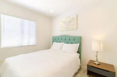 a bedroom with a white bed with a blue headboard at Sunny 1 Bedroom in the Heart of Venice Beach - #3 in Los Angeles