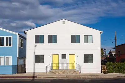 a white house with yellow doors on a street at Sunny 1 Bedroom in the Heart of Venice Beach - #3 in Los Angeles