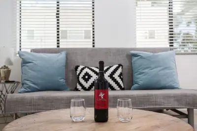 a bottle of wine sitting on a table with two glasses at Sunny 1 Bedroom in the Heart of Venice Beach - #3 in Los Angeles