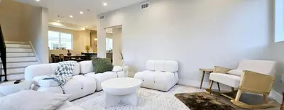 a living room with a white couch and chairs at Southwest Stay in Los Angeles
