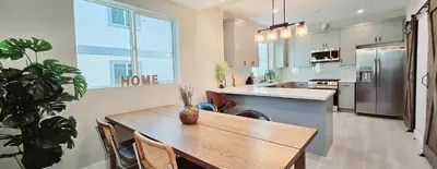a kitchen with a wooden table and a dining room at Southwest Stay in Los Angeles