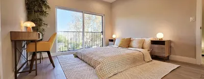 a bedroom with a bed and a large window at Southwest Stay in Los Angeles