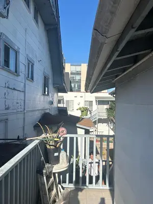 a balcony of a building with a table and chairs at Santa Monica Stays in Los Angeles