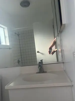 a bathroom with a sink and a mirror at Santa Monica Stays in Los Angeles