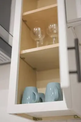 a cupboard with two blue cups and wine glasses at 2 TVs - Vaulted Ceiling - Private Kitchen & Entrance in Walnut
