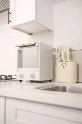 a white kitchen with a microwave and a sink at 2 TVs - Vaulted Ceiling - Private Kitchen & Entrance in Walnut