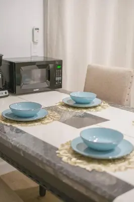 two blue bowls on a table in front of a microwave at 2 TVs - Vaulted Ceiling - Private Kitchen & Entrance in Walnut