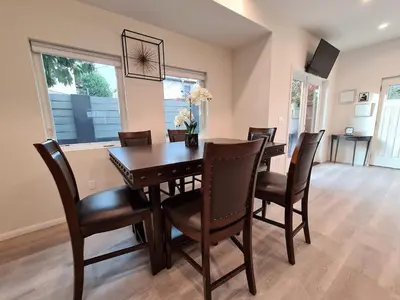 a dining room with a wooden table and chairs at Prime LA 2 bedroom & 3 bath home Beverly Hills adj in Los Angeles