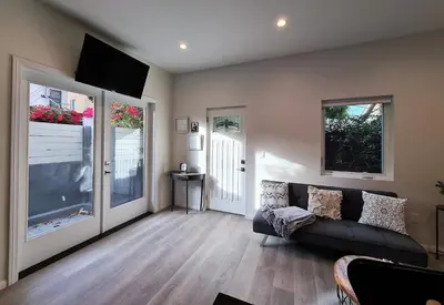 a living room with a couch and a flat screen tv at Prime LA 2 bedroom & 3 bath home Beverly Hills adj in Los Angeles