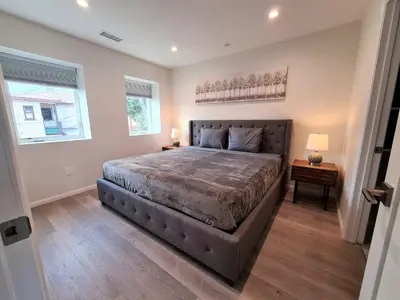 a bedroom with a large bed and two windows at Prime LA 2 bedroom & 3 bath home Beverly Hills adj in Los Angeles