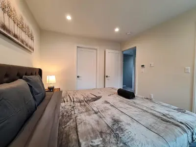 a bedroom with a large bed and a couch at Prime LA 2 bedroom & 3 bath home Beverly Hills adj in Los Angeles