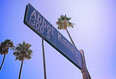 a blue street sign with palm trees in the background at Sunny Studio in the Heart of Venice Beach - #5 in Los Angeles