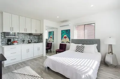 a white bedroom with a bed and a kitchen at Sunny Studio in the Heart of Venice Beach - #5 in Los Angeles