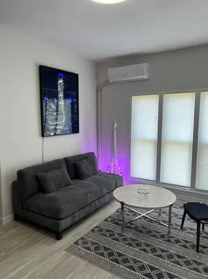 a living room with a couch and a table at Marilyn Studio Apartment in Koreatown in Los Angeles