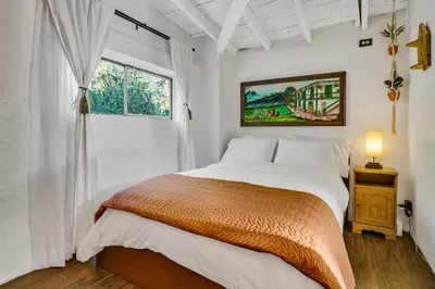 a white bedroom with a bed and a window at Private Romantic Escape, Hidden Gem w Hot Tub in Chatsworth Lake Manor