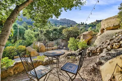 a patio with chairs and a table with a view at Private Romantic Escape, Hidden Gem w Hot Tub in Chatsworth Lake Manor