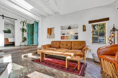 a living room with a couch and a table at Private Romantic Escape, Hidden Gem w Hot Tub in Chatsworth Lake Manor