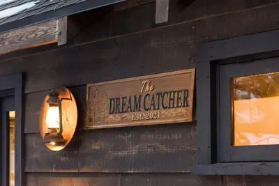 a sign on the side of a building with a light at Dream Catcher Retreat in Big Bear Lake