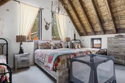 a bedroom with a bed and a tv in it at Dream Catcher Retreat in Big Bear Lake