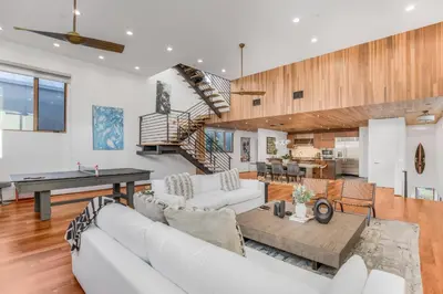 a living room with a white couch and a table at Cedar Loft Villa in Los Angeles
