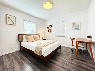 a bedroom with a bed and a desk at Cozy 2BR Getaway with Pool, Close to SoFi - MKMD1 in Los Angeles