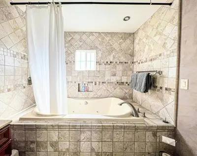 a bath tub in a bathroom with a window at Cozy 2BR Getaway with Pool, Close to SoFi - MKMD1 in Los Angeles