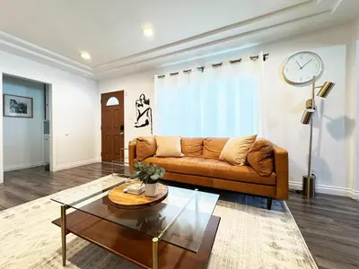 a living room with a couch and a coffee table at Cozy 2BR Getaway with Pool, Close to SoFi - MKMD1 in Los Angeles