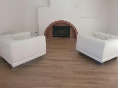 two white couches in a living room with a fireplace at 3BR & Loft near Palmdale Hospital in Palmdale