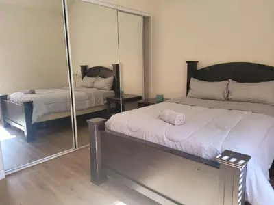 a bedroom with a bed and a mirror at 3BR & Loft near Palmdale Hospital- Shared Hm in Palmdale