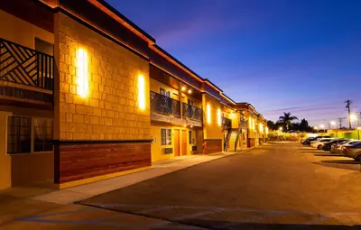 a building with lights on the side of a street at Colonial Palace Inn in Downey