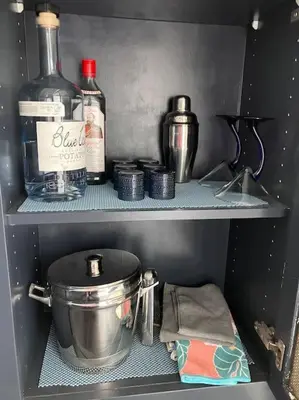 a refrigerator shelf with bottles of alcohol and a pot at Luxe Suite Convention Center Partial Ocean View with Free Parking in Long Beach