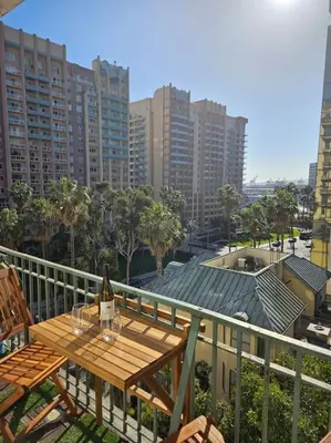 a wooden table on a balcony with a bottle of wine at Luxe Suite Convention Center Partial Ocean View with Free Parking in Long Beach