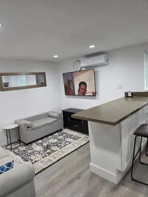 a kitchen and living room with a counter and a couch at RGS cottage in Los Angeles in Los Angeles