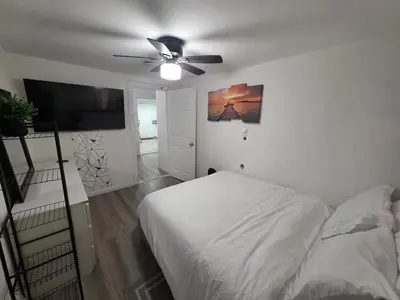 a bedroom with a bed and a ceiling fan at RGS cottage in Los Angeles in Los Angeles
