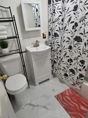 a bathroom with a toilet and a sink and a shower at RGS cottage in Los Angeles in Los Angeles