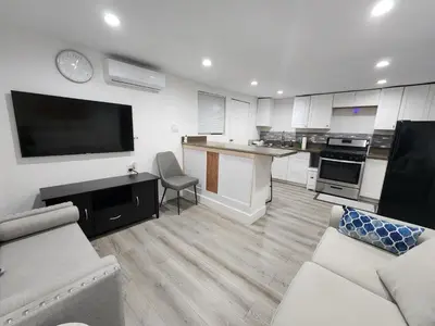 a living room with a couch and a tv and a kitchen at RGS cottage in Los Angeles in Los Angeles