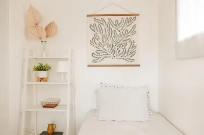 a room with a bed and a picture on the wall at Walk to Beach and Restaurants - Easy Parking in Long Beach