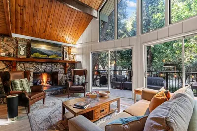 a living room with a couch and a fireplace at Fleming Creek Hideaway, Next to Creek, Fire-Pit! in Lake Arrowhead