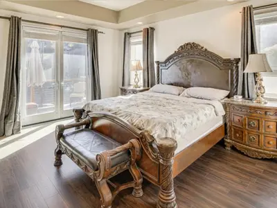 a bedroom with a large bed and a wooden dresser at 3BR Mountain Retreat with 2 Executive Suites & Scenic Views Sleeps 6 in Newbury Park
