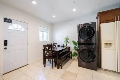 a laundry room with a table and a washing machine at 22ppl Garage Parking Btw Disney Hollywood Monterey Park Chinatown in Monterey Park