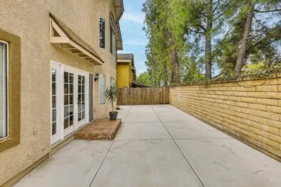 a driveway leading to a house with a brick wall at 2 Mi to Victoria Gardens Rancho Cucamonga Haven in Rancho Cucamonga
