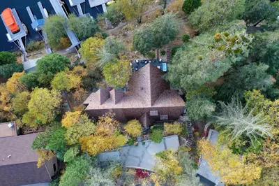 an aerial view of a building in the middle of trees at Rocky Point Paradise Bay Lake Front Hot TUB 10 out of 10 in Lake Arrowhead