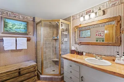 a bathroom with a sink and a shower at Rocky Point Paradise Bay Lake Front Hot TUB 10 out of 10 in Lake Arrowhead