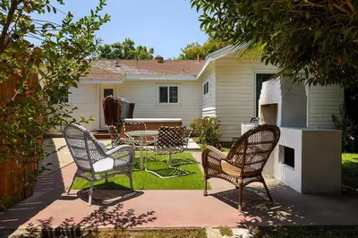 a group of chairs and a table in a yard at 1970s Style Cozy Home with Fireplace Yard and Hot Tub in Inglewood