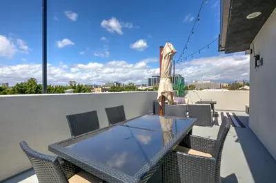 a glass table and chairs on a balcony at La Veranda View Hideaway in Los Angeles