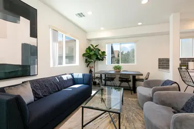a living room with a blue couch and a table at La Veranda View Hideaway in Los Angeles