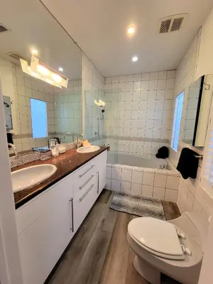 a bathroom with a sink and a toilet and a tub at 3 bedroom top story apartment near Pico blvd in Los Angeles