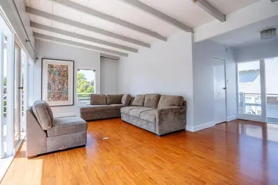 a living room with a couch and a chair at Sunset Hilltop Flat in Los Angeles