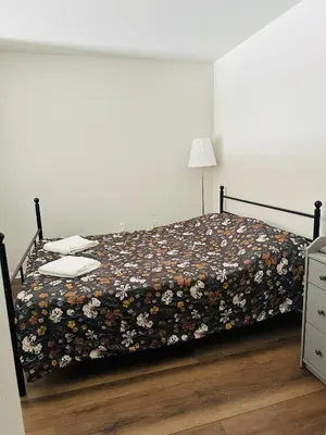 a bedroom with a bed with a floral bedspread at Loft Style,2 Beds ,Flexible self check in,Pool in Marina del Rey