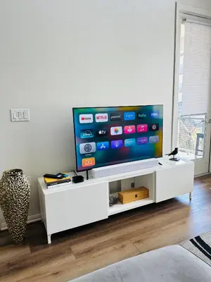 a living room with a flat screen tv on a white cabinet at Loft Style,2 Beds ,Flexible self check in,Pool in Marina del Rey